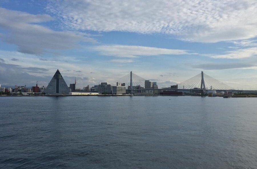The Aomori Bay Bridge framing the ASPAM building at sunset
