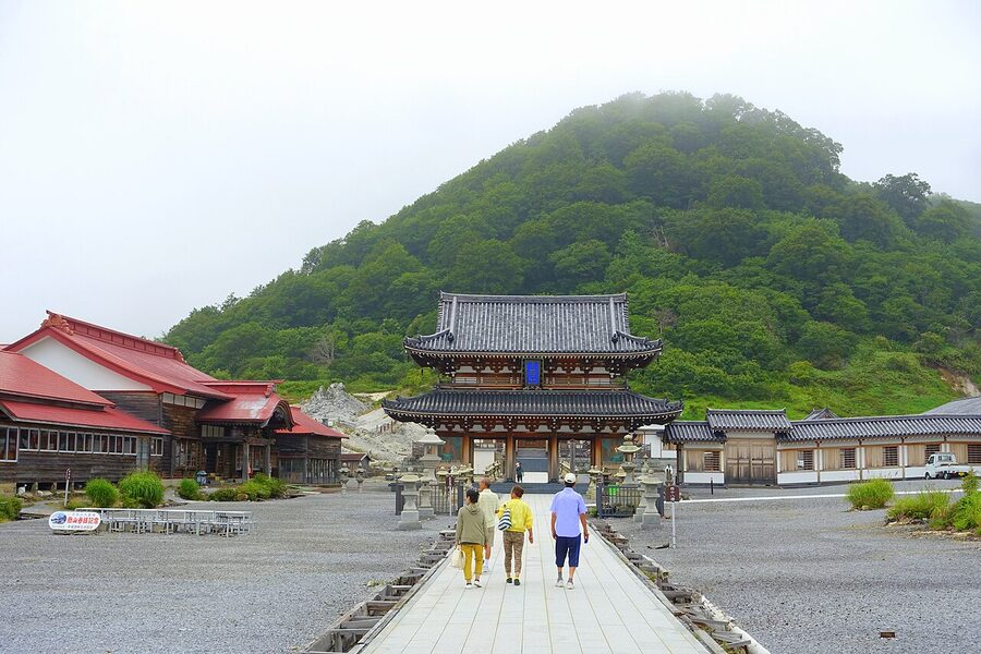 The temple gate of Bodaiji at Mount Osore with sulphurous steam rising in the background