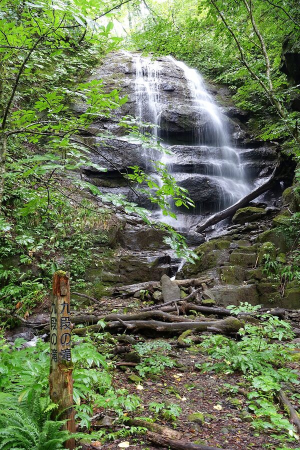 Kudan Falls cascading over moss-covered rocks on the Oirase Stream