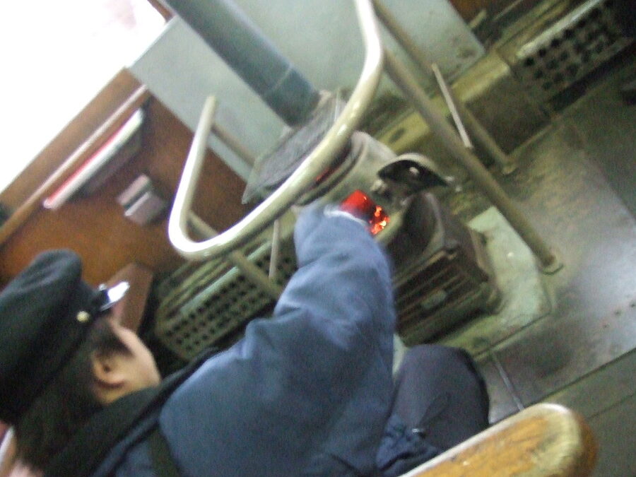 A conductor on the Tsugaru Railway stove train wearing a winter overcoat