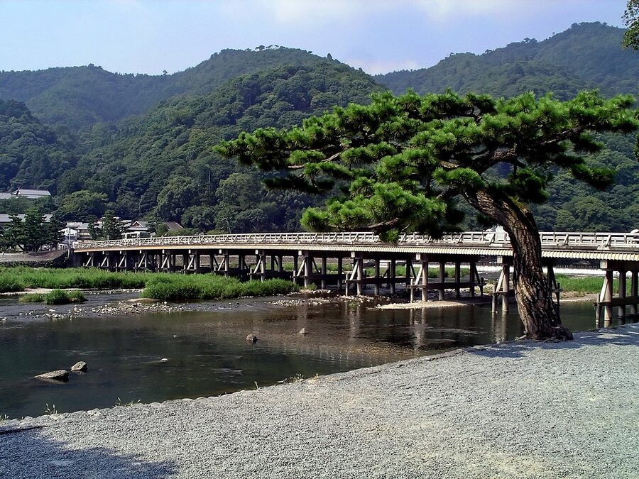 Togetsukyo bridge over Hozu river with mountain backdrop midday Kyoto