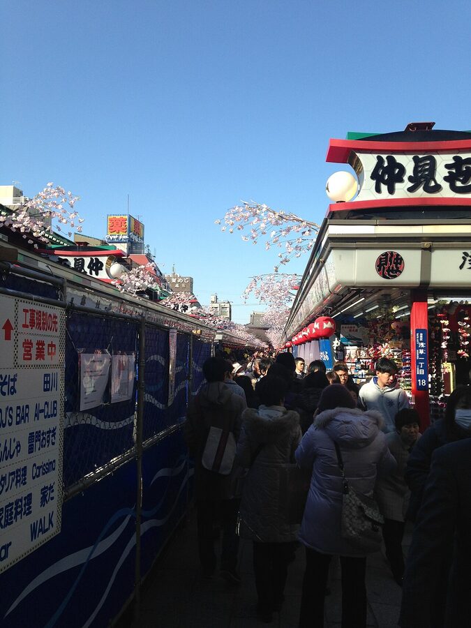 Visitors walking down Nakamise shopping street toward Senso-ji main hall, Asakusa, Tokyo