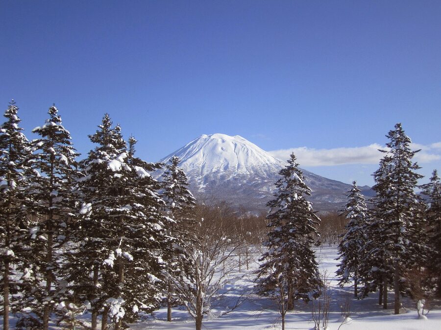 Mount Yotei reflected behind a snowy Niseko slope