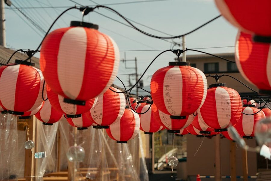 Red and white paper lanterns strung up at a summer festival in Japan