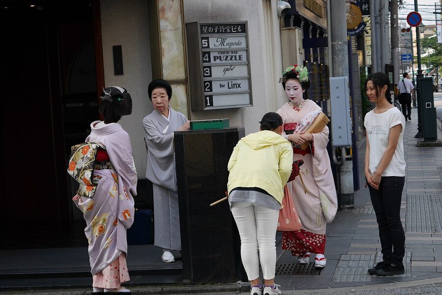A geiko and a maiko on a Kyoto street together