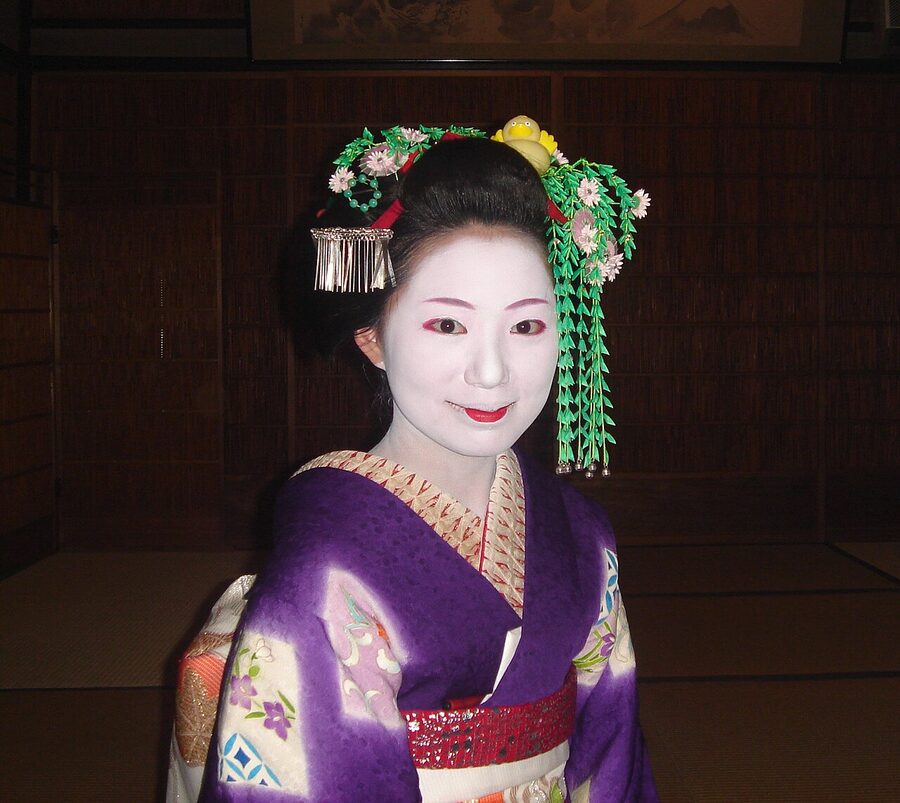 Maiko Mamechiho walking in Gion district of Kyoto