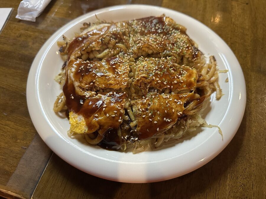 Hiroshima-style okonomiyaki served on the iron griddle
