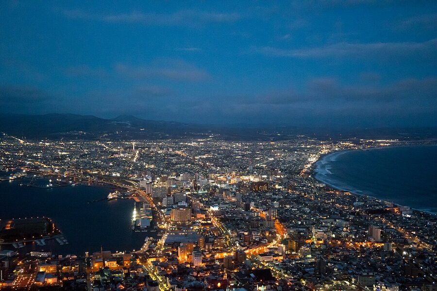 Aerial night view of Hakodate showing the narrow waist between bay and harbour.