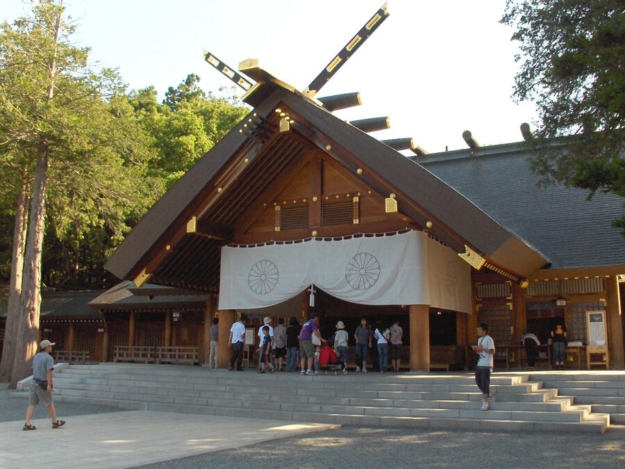 Hokkaido Shrine main hall with cherry blossom around the entrance