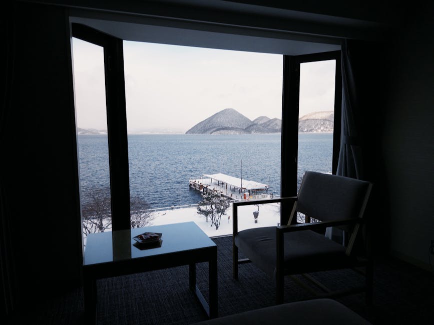 Lake Toya seen through a wooden window from a ryokan room in winter.