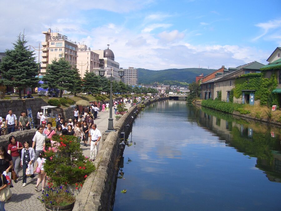 Otaru Canal lined with stone warehouses on a summer evening.