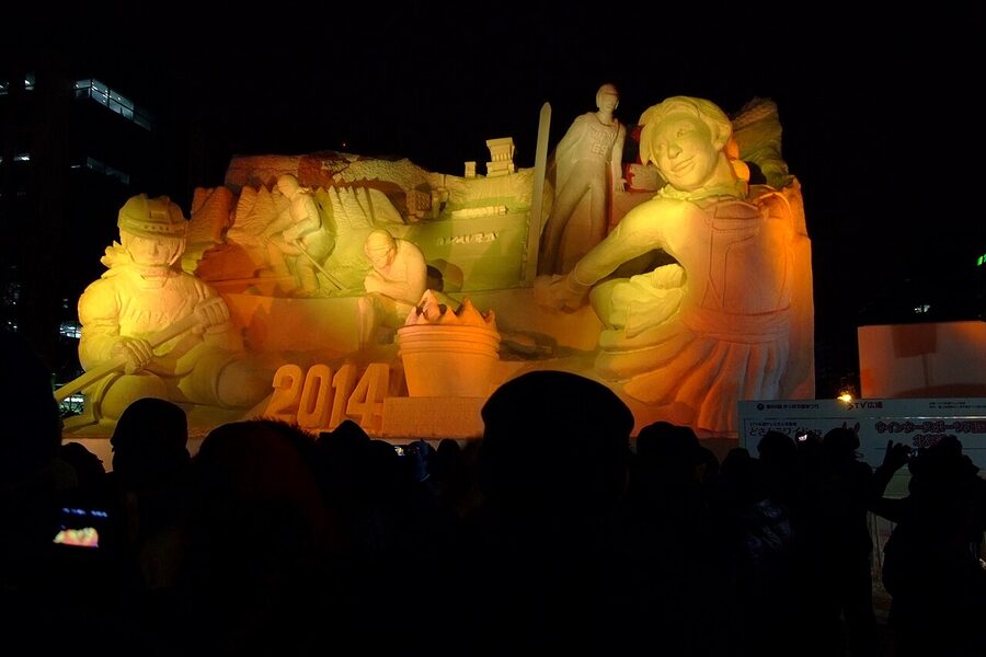 Crowds in front of large snow sculptures at the Sapporo Snow Festival on the Odori site.