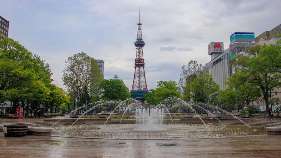 Sapporo TV Tower above a fountain in Odori Park, late spring.
