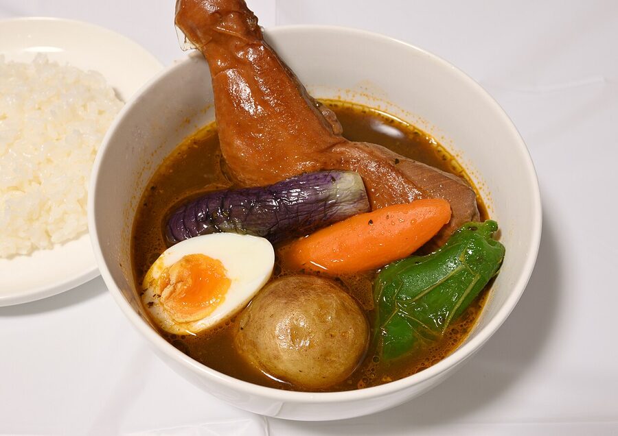 A Sapporo-style soup curry with chicken leg, broccoli and pumpkin.