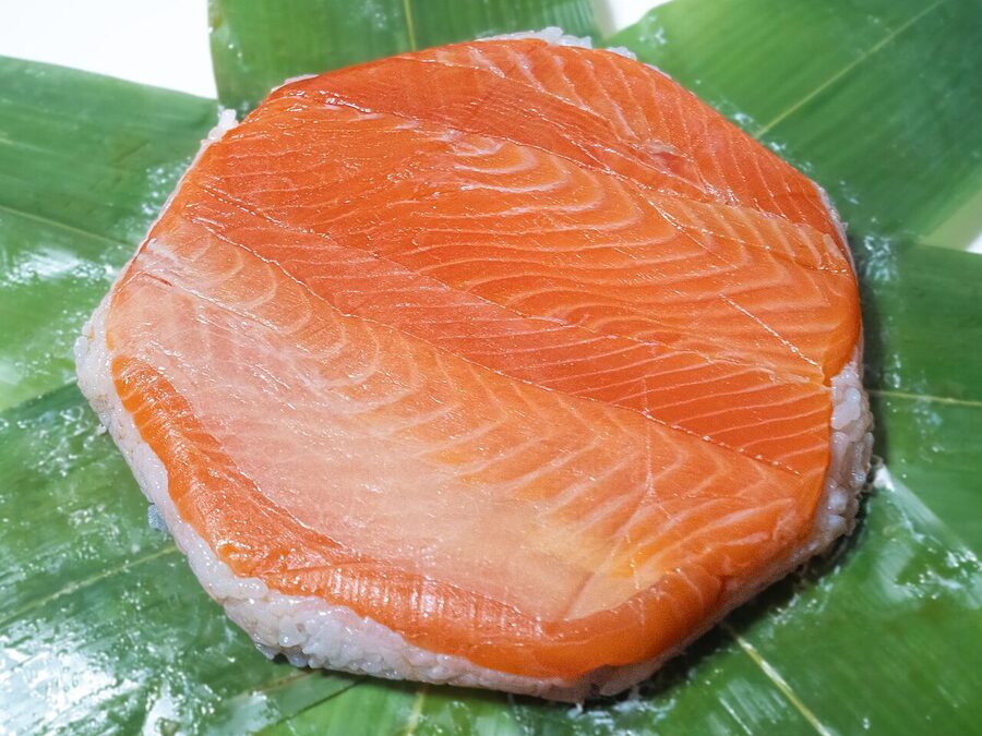 A masuzushi pressed trout sushi from Toyama in lacquered bamboo packaging