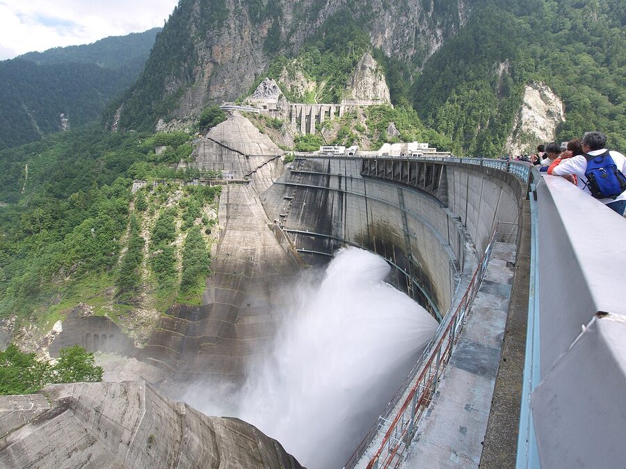 Kurobe Dam with onlookers on the dam crest viewing platform