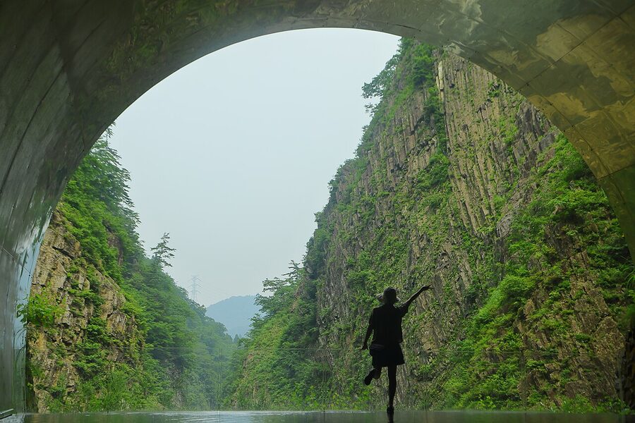 Kiyotsu Gorge tunnel of light installation reflecting in shallow water