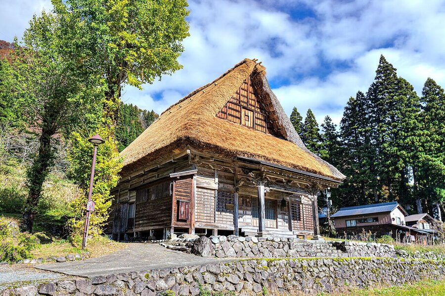 Ainokura village in Gokayama, with gassho-zukuri farmhouses against a backdrop of forested mountains