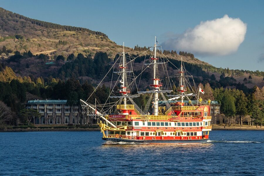 A Hakone sightseeing pirate ship on Lake Ashi with the lake's shoreline