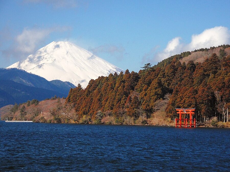 Mt. Fuji rising over Lake Ashi with Hakone Shrine torii visible in the lake