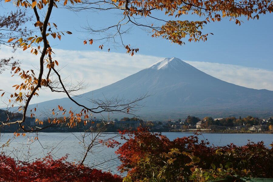 Mt. Fuji over Lake Kawaguchi framed by autumn maple leaves