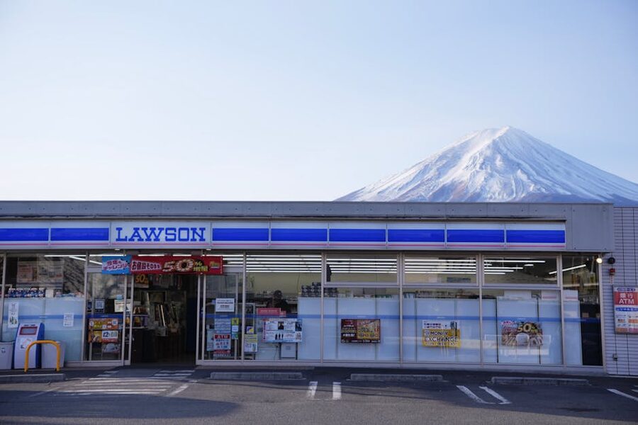 Mt. Fuji rising behind a Lawson convenience store in Fujikawaguchiko