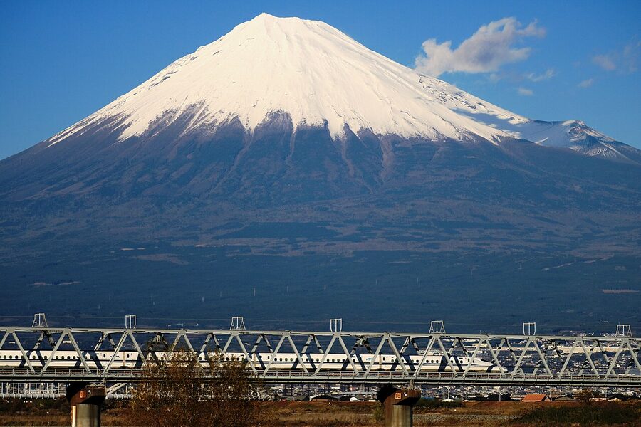 A shinkansen passing in front of Mt. Fuji on a clear day