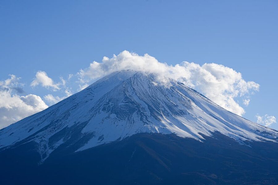 Snow-capped Mt. Fuji with a bare cone against clear blue winter sky