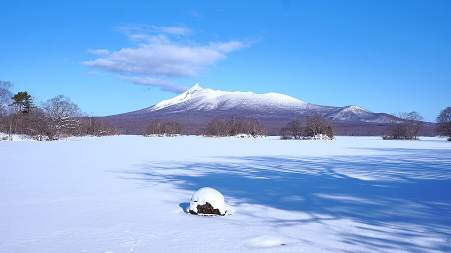 Mount Komagatake in southern Hokkaido seen across snow-covered fields in winter