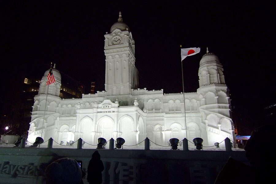 A multi-storey snow sculpture at a past Sapporo Snow Festival, lit at night