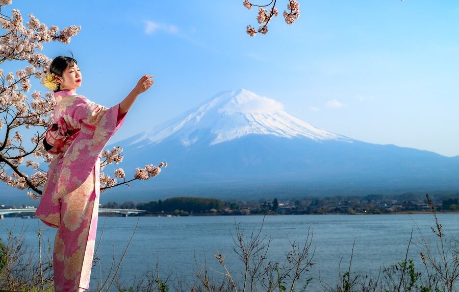 Mount Fuji and cherry blossoms with a kimono-clad figure in the foreground, Lake Kawaguchi area.