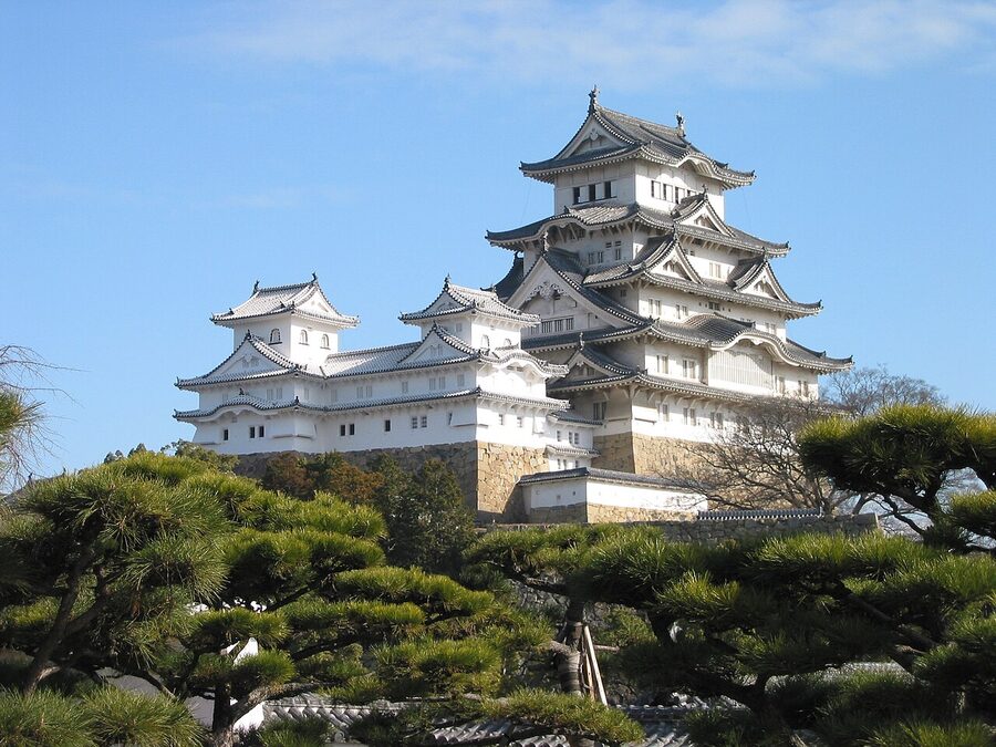 Himeji Castle keep, white plaster facade, multi-tiered roof, photographed from the south approach.