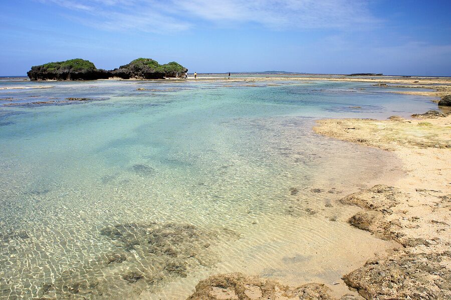 Hoshizuna no Hama (star sand beach) on Iriomote Island, foraminifera sand under shallow turquoise water.