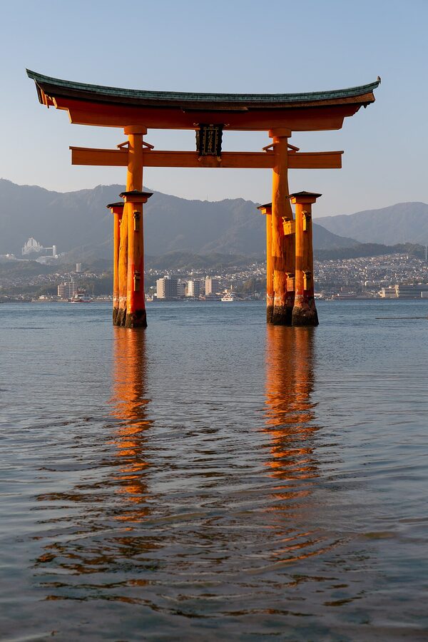 The 16m floating torii gate of Itsukushima Shrine at high tide, vermilion against the Seto Inland Sea.