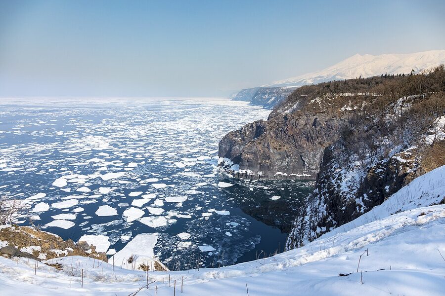 Drift ice along the Shiretoko Peninsula coast, ice plates extending to the horizon.