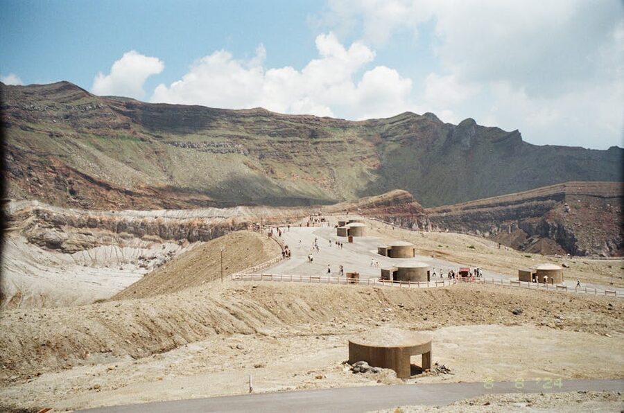 Tourists walking near Mt Aso crater rim, Kumamoto