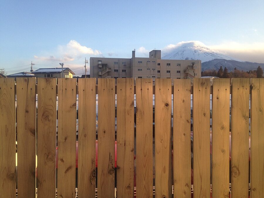 Mount Fuji rising behind Fujisan Station with red structure in foreground