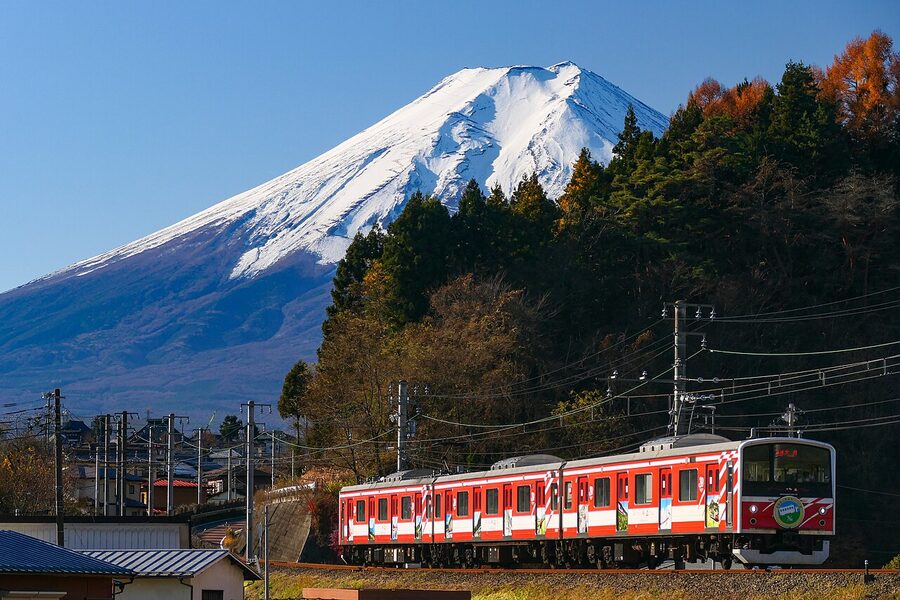 Fujikyu Railway Series 6000 train running below Mt Fuji