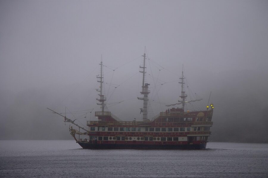 Lake Ashi in Hakone wrapped in fog with a pirate ship in the distance
