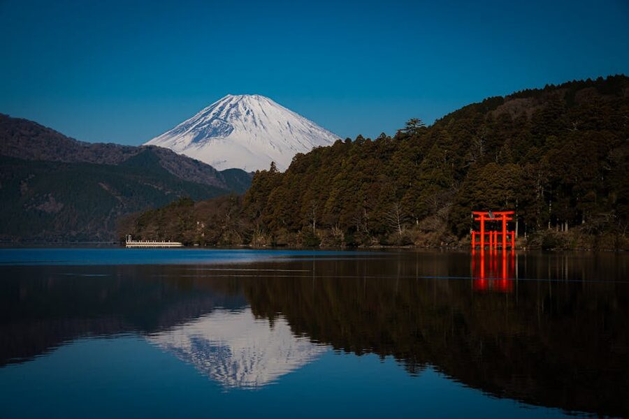 Mount Fuji and the red Hakone Shrine torii reflected in Lake Ashi