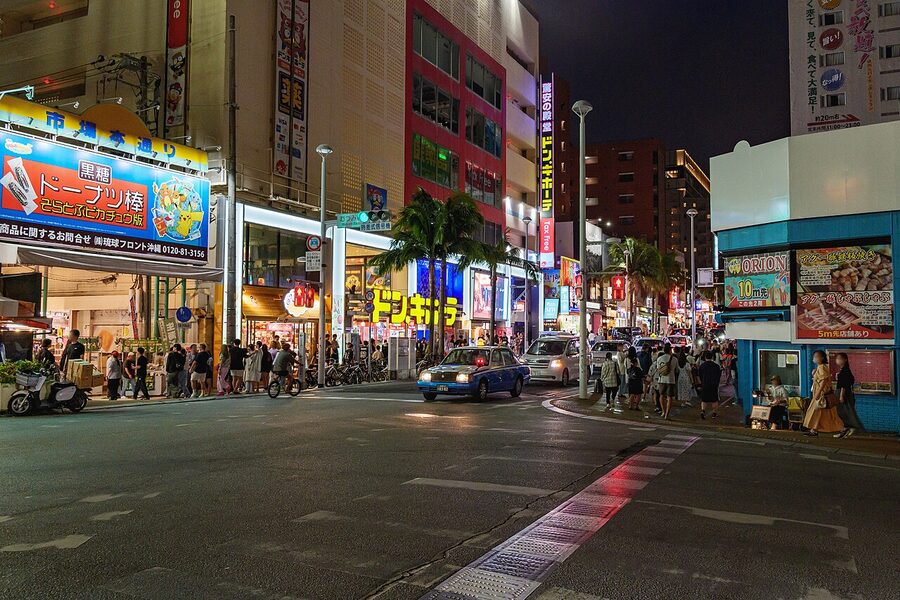 Kokusai-dori at night with neon and crowds