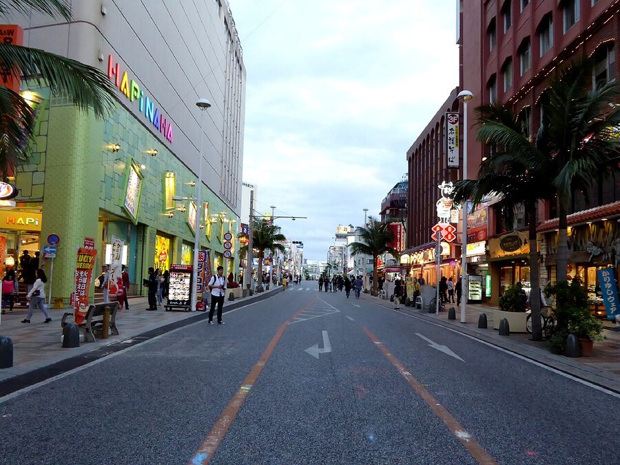 Kokusai-dori in Naha at night, neon shop signs and sidewalks busy with people