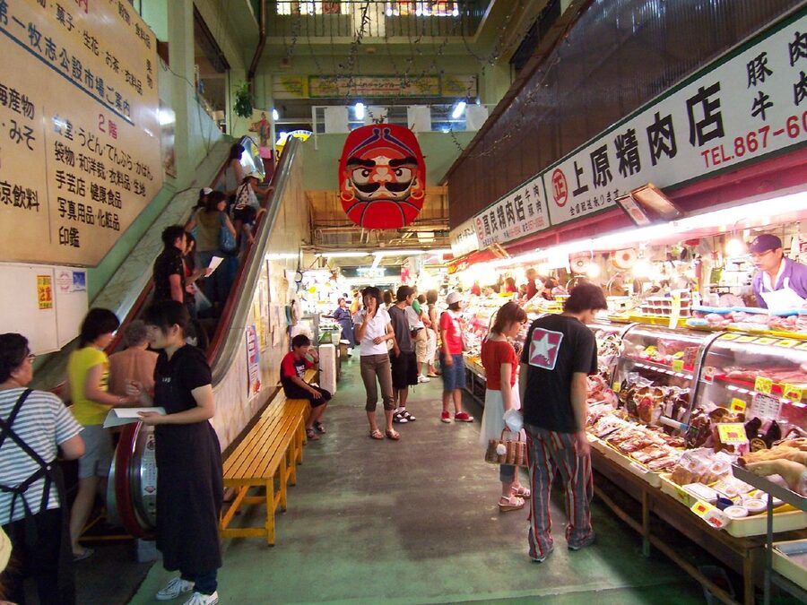 Inside Makishi Public Market in Naha, fresh fish on ice and meat counters