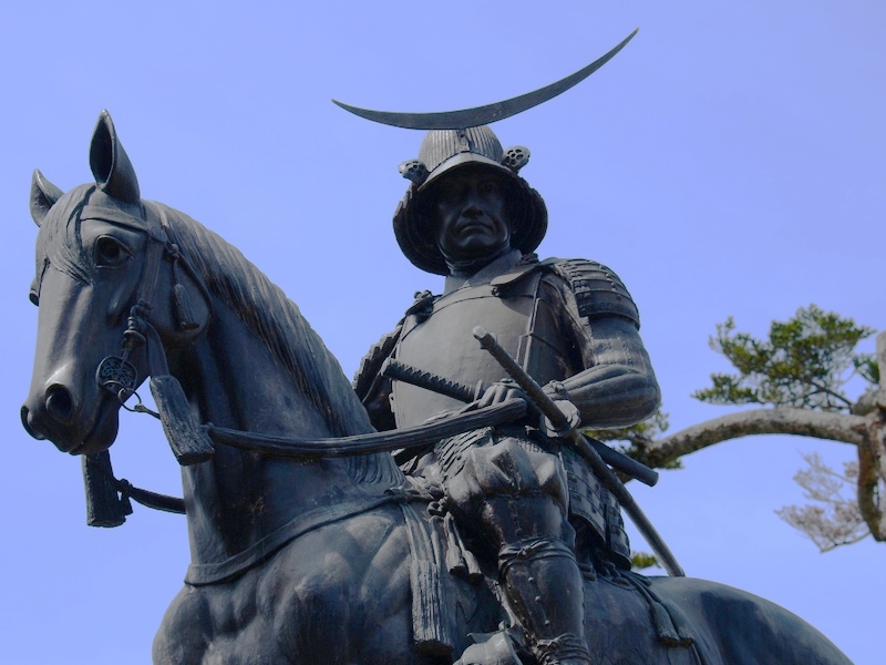 Date Masamune statue at Aoba Castle ruins seen from below in summer light