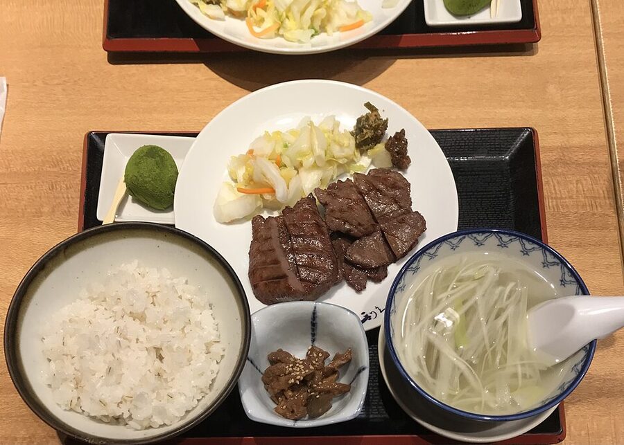 Grilled beef tongue teishoku set on a brown lacquer tray, photographed in a Sendai restaurant