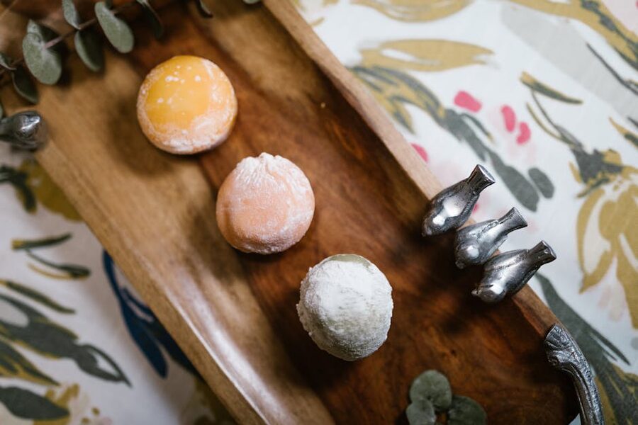 Plate of pastel-coloured Japanese mochi sweets on a wooden tray