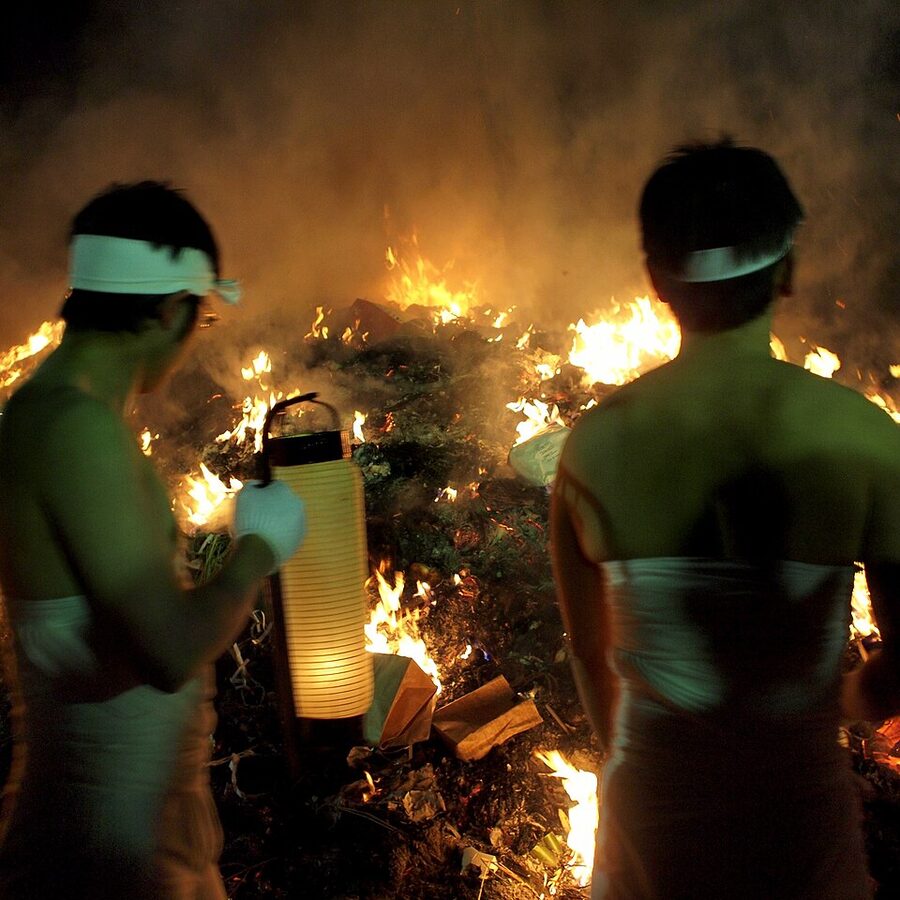 Crowd at Osaki Hachimangu shrine at the Dontosai festival in January with bonfires and lit torches