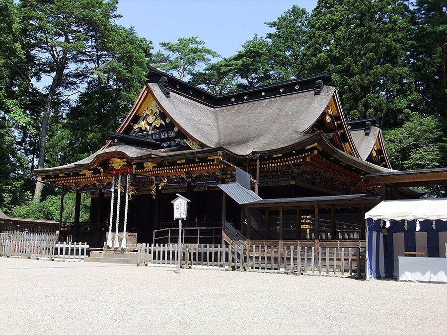Black-and-gold Osaki Hachimangu shrine main hall with carved decorative panels