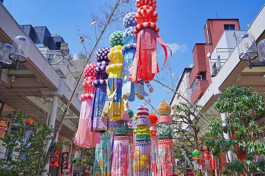 Long colourful tanzaku paper streamers hanging from bamboo poles in a Sendai shopping arcade