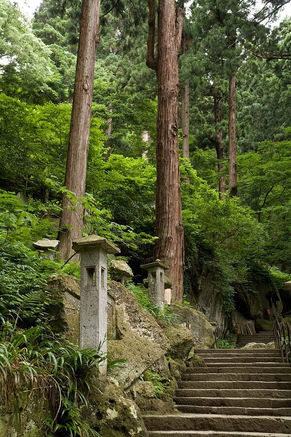 Risshakuji temple buildings perched on a forested cliff at Yamadera in Yamagata Prefecture